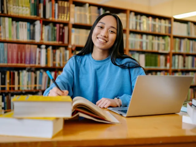 College girl in a library studying